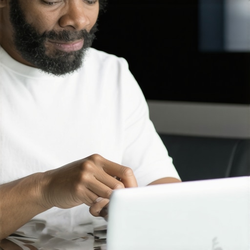 Analyzing Local SEO Data Business owner reviewing local SEO metrics on laptop